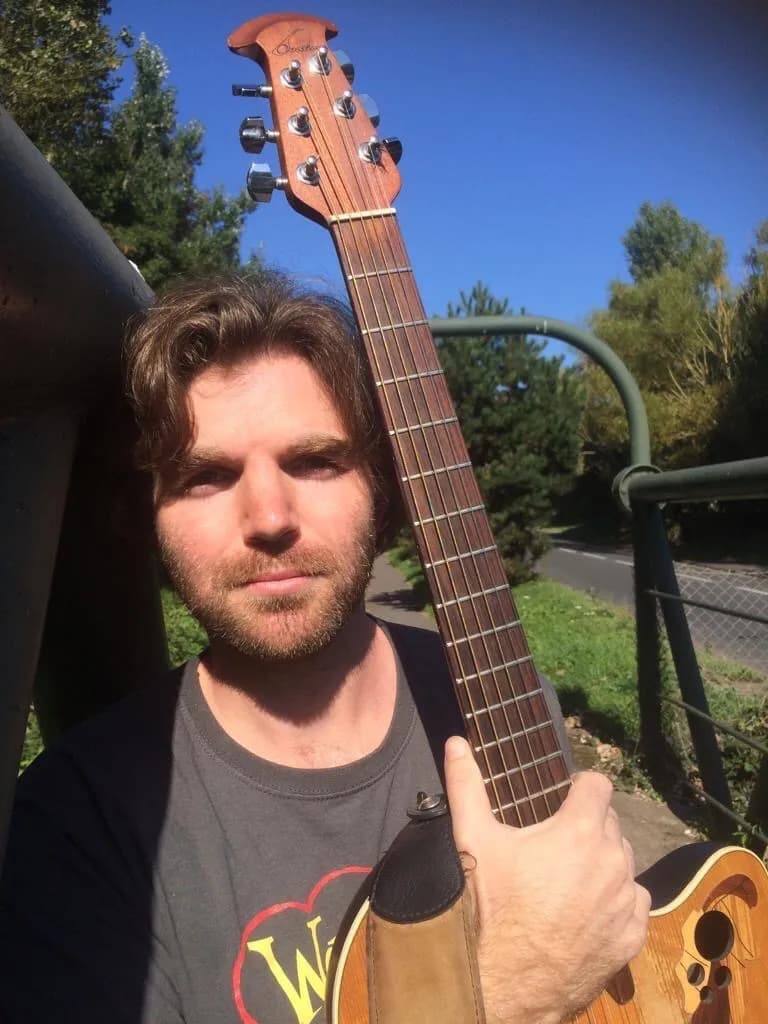 Sunlit Serenade: A Portrait of a Casual Musician with Guitar in Nature
