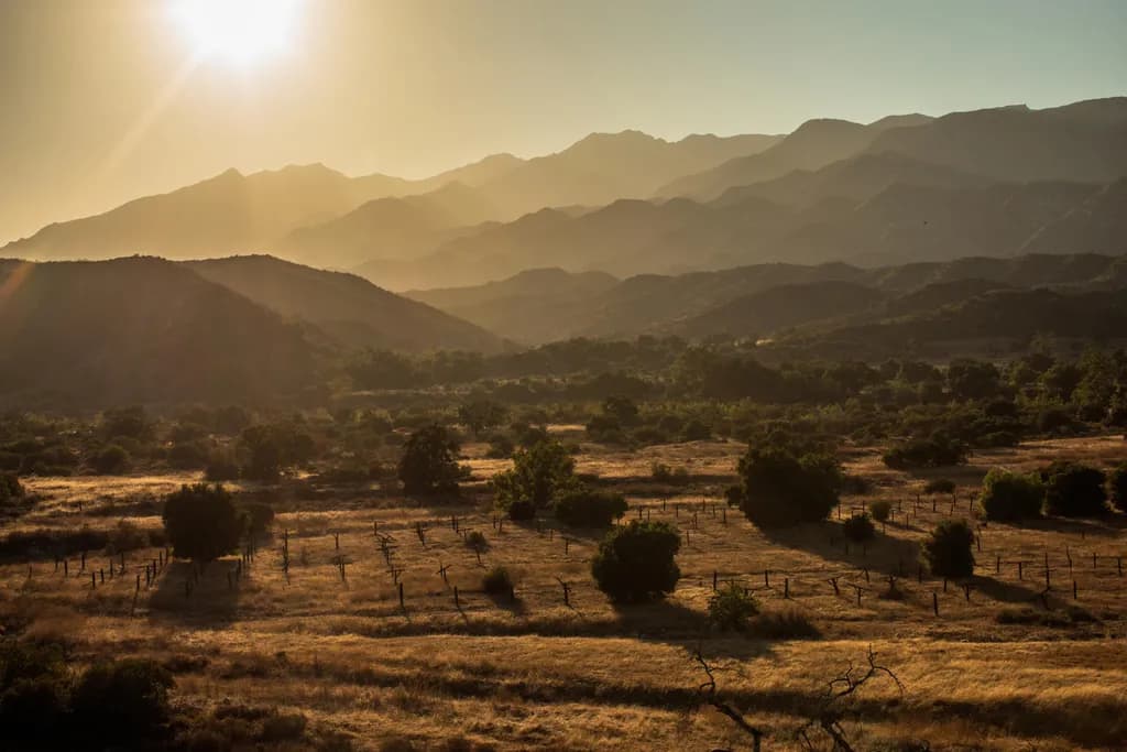 Whispers of Dusk: A Golden Embrace Over the Mountain Valleys