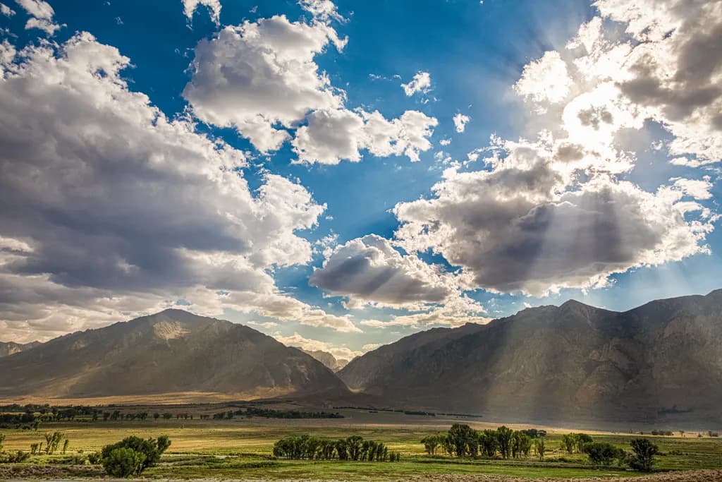 Whispers of Light: A Majestic Mountain Landscape Under a Dramatic Sky