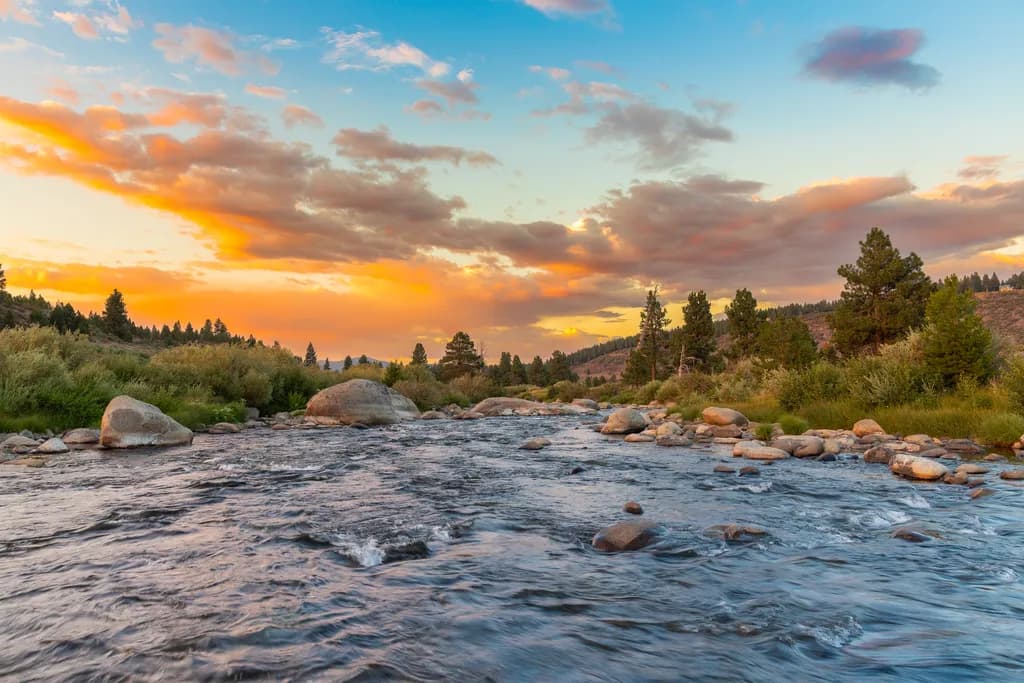 Whispers of the River: A Serene Sunset Over Rocky Waters