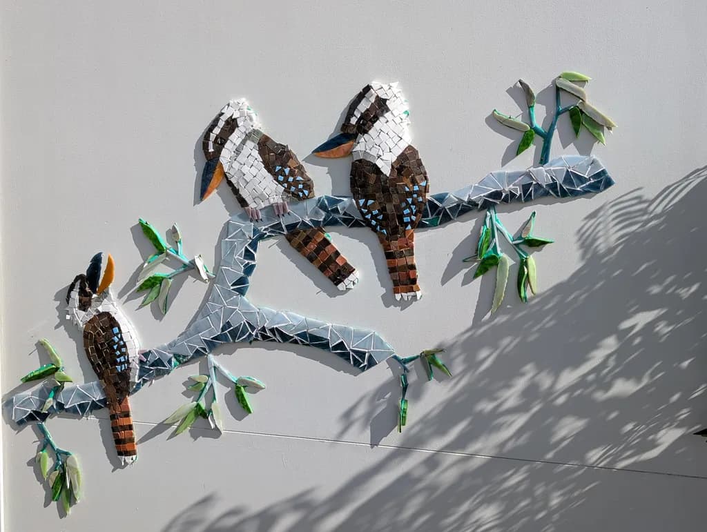 Whispers of Nature: A Colorful Mosaic of Birds and Leaves on a Branch