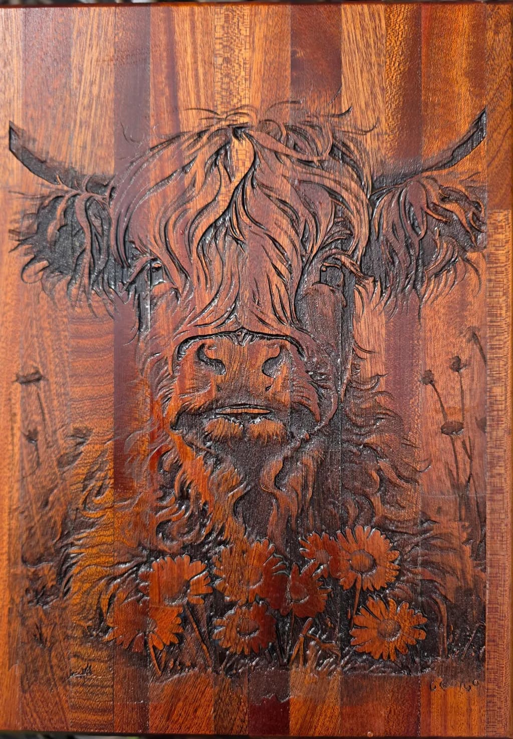 Highland Harmony: A Textured Floral Carving of a Cow in Wood