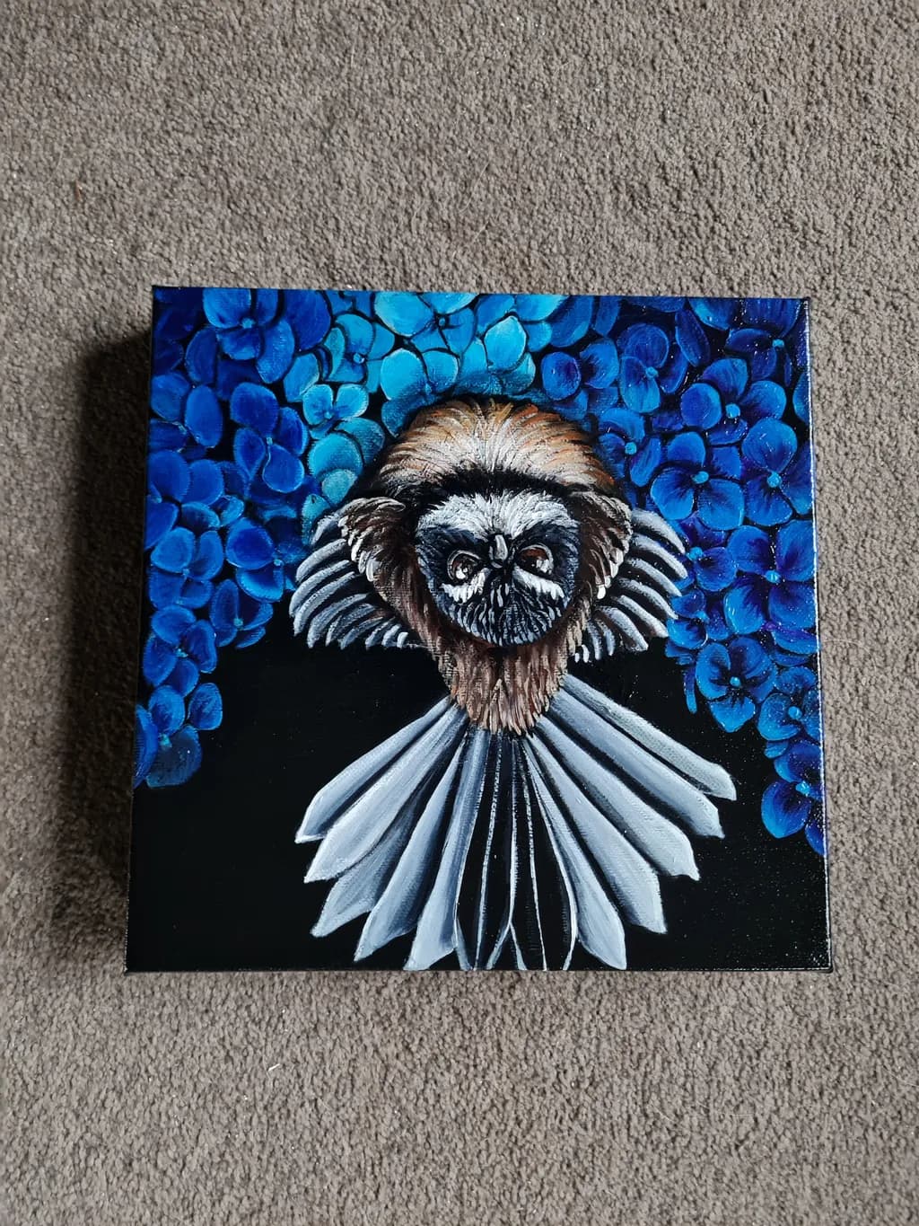 Whimsical Harmony: A Majestic Owl Amidst Vibrant Blue Blossoms