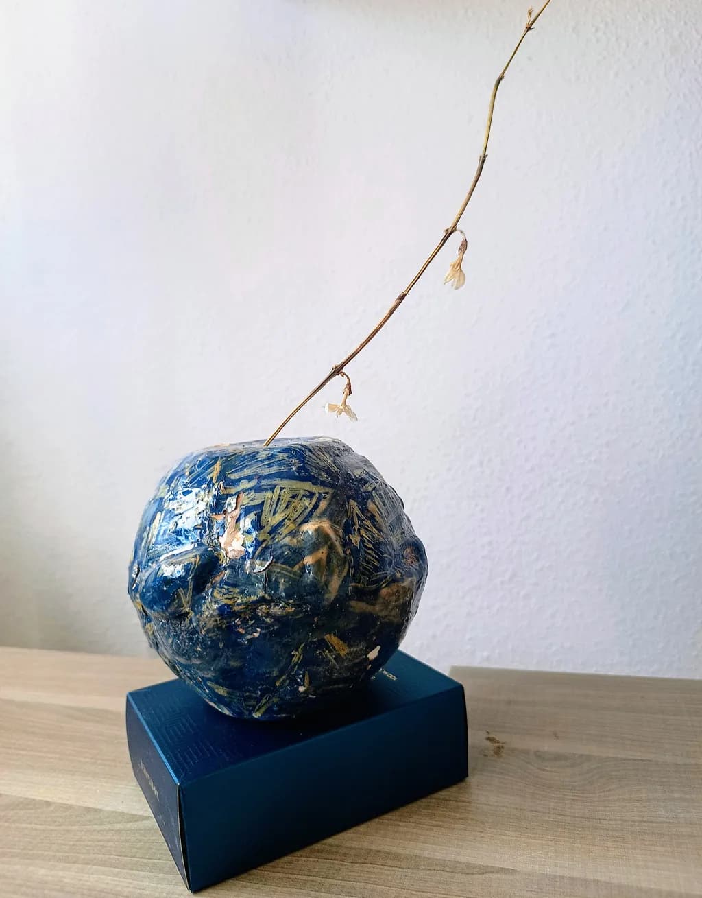 Whispers of Nature: A Blue Abstract Sculpture with Delicate Floral Accent