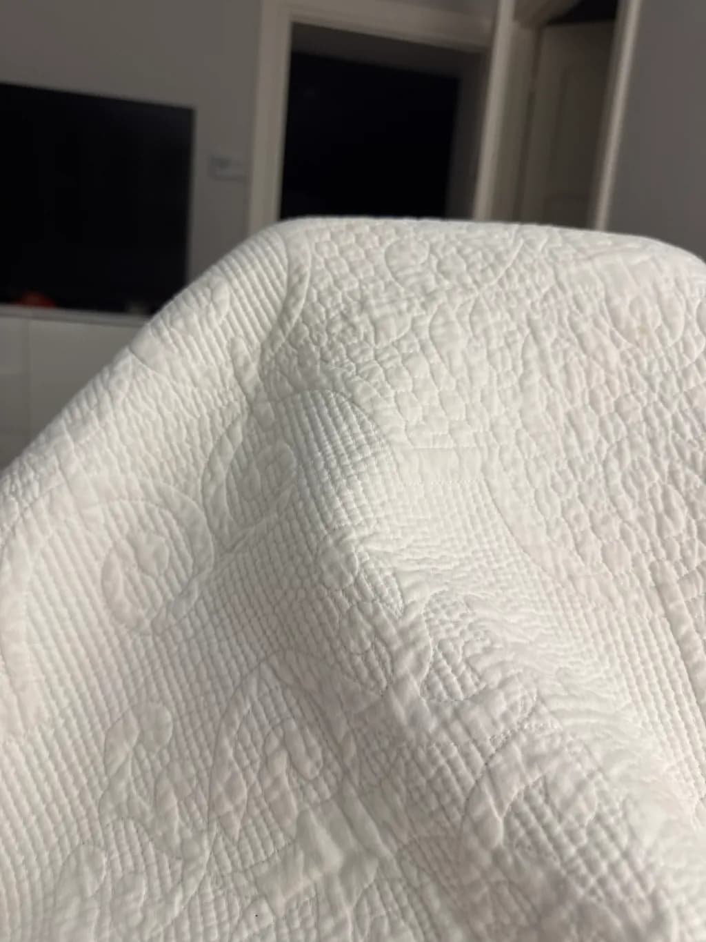 Whispers of Softness: A Quilted Embrace in White Fabric Texture