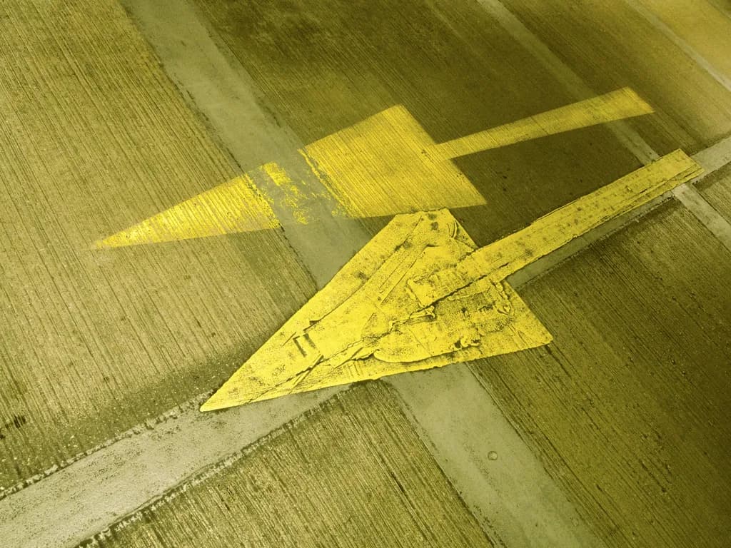 Urban Direction: A Study in Yellow Arrows and Concrete Textures