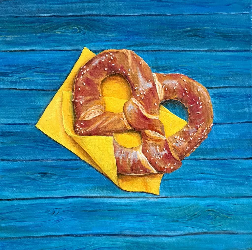 Golden Pretzel Delight on Vibrant Blue Canvas
