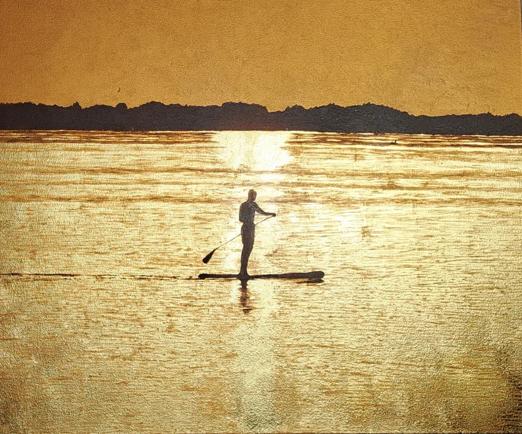 Golden Serenity: A Solitary Paddleboarder at Sunset