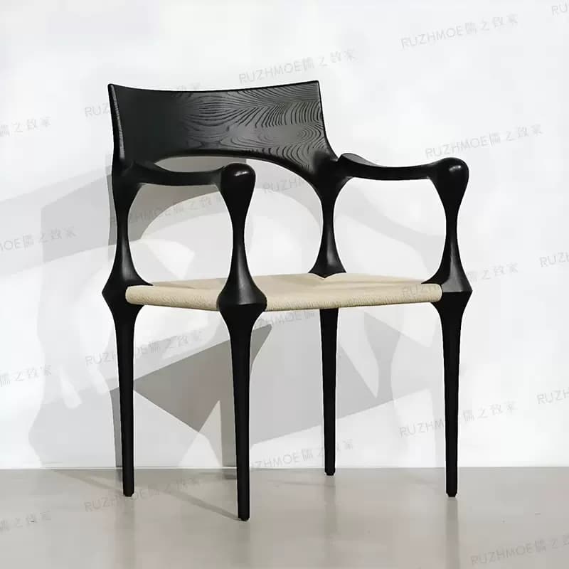 Elegant Black Sculptural Chair with Natural Fiber Seat