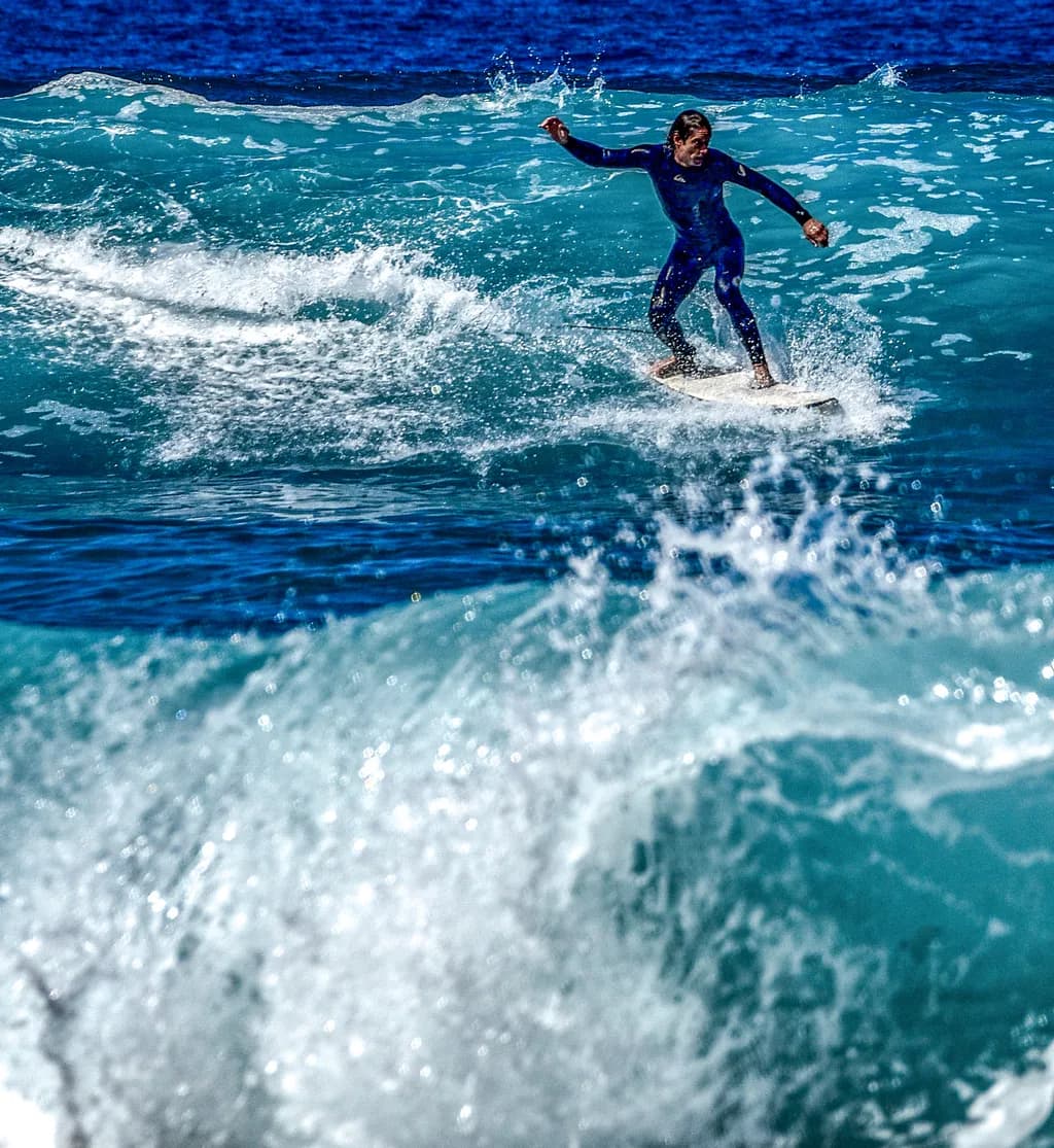 Riding the Blue Wave: A Dynamic Surfing Experience in Ocean Action