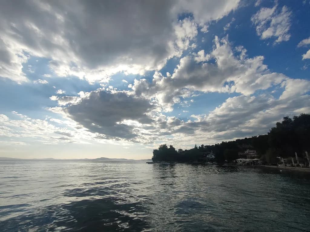 Serenity Beneath the Clouds: A Tranquil Waterscape at Dusk