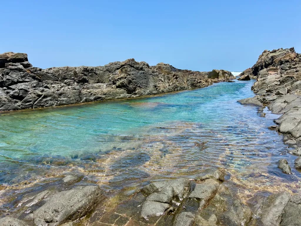 Serenity by the Shore: A Tranquil Tide Pool Escape Amidst Rocky Coastlines