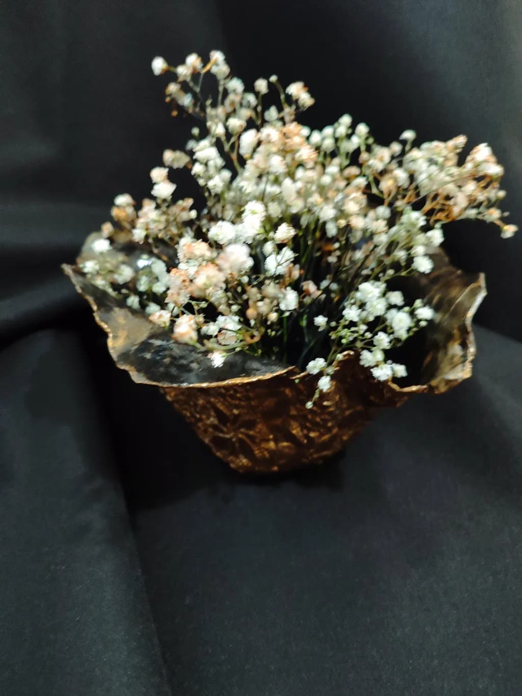 Delicate Elegance: A Floral Arrangement in a Decorative Black Bowl