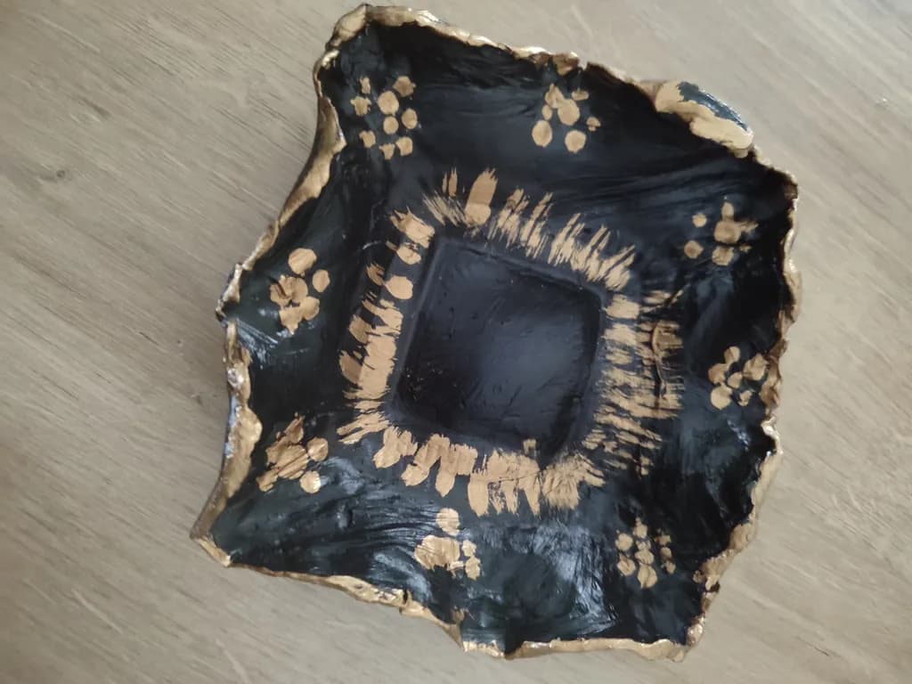 Elegant Black and Gold Textured Ceramic Bowl with Artistic Floral Design
