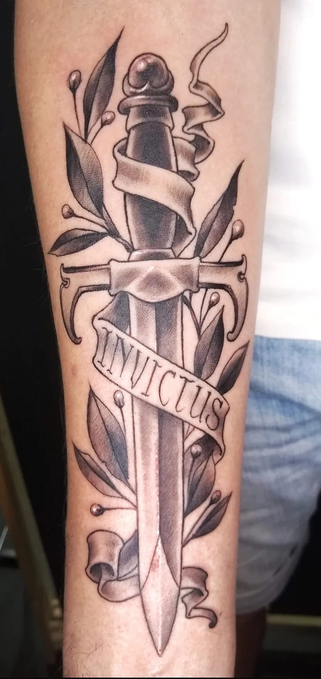 Invictus: A Sword of Strength and Resilience Tattoo Design