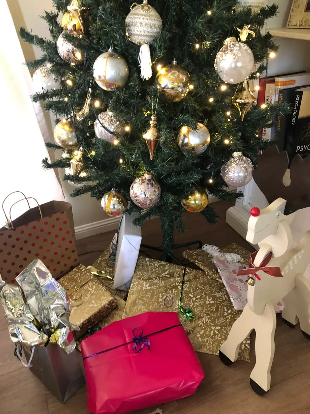 Whimsical Holiday Cheer: A Festive Christmas Tree with Gifts and Ornaments