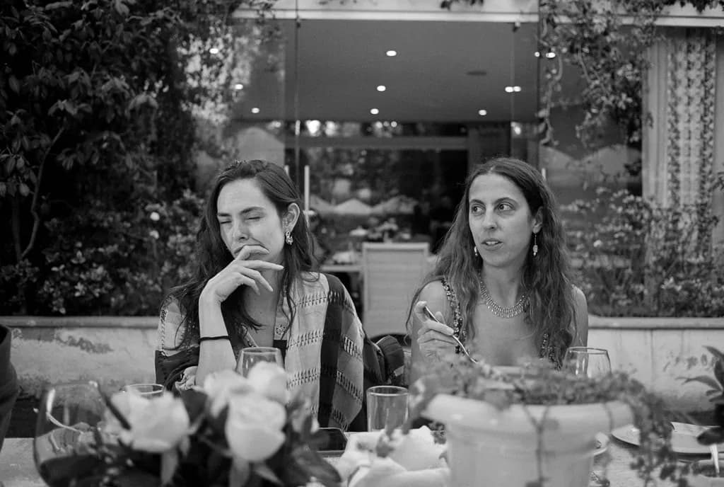 Whispers of Connection: A Moment Captured in Black and White Elegance