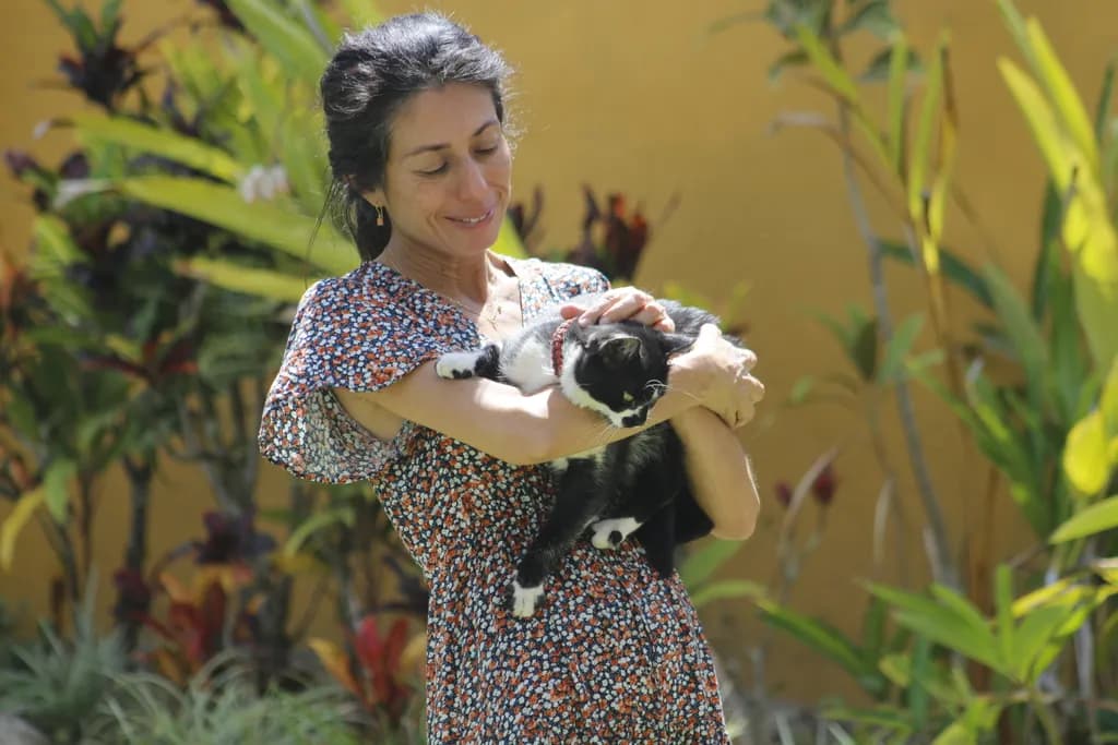 Whispers of Joy: A Serene Moment with a Beloved Cat in a Lush Garden Setting