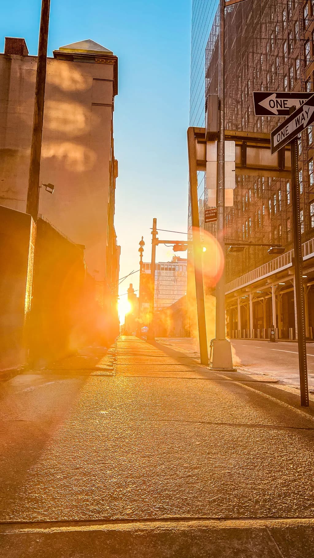 Urban Sunset: A Glimpse of Light and Reflection in the City Streets