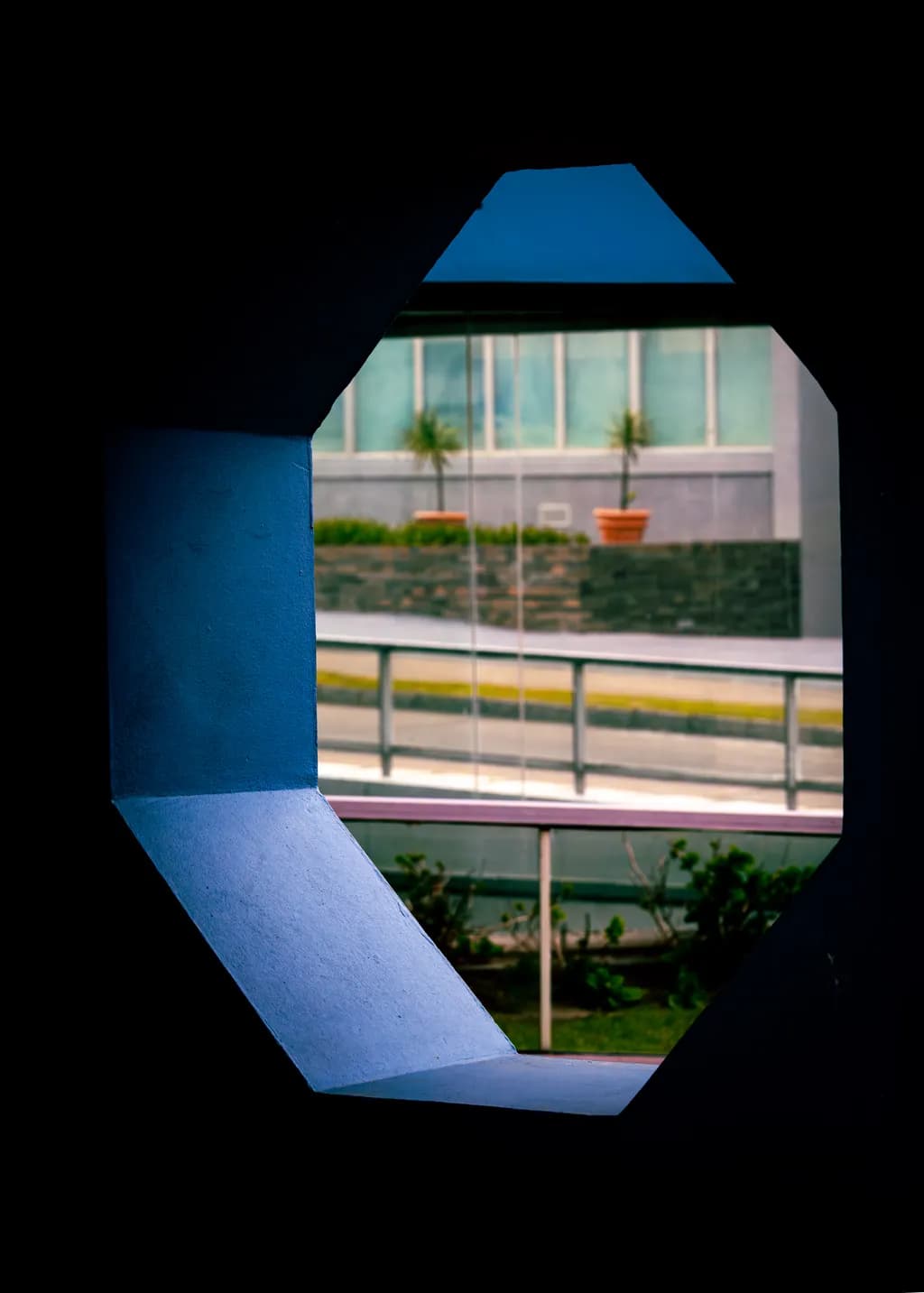 Framed Perspectives: A Glimpse Through the Octagonal Window of Urban Serenity