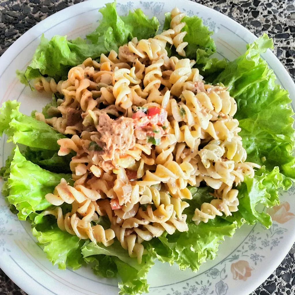 Whimsical Greens: A Vibrant Pasta Delight on a Bed of Fresh Lettuce