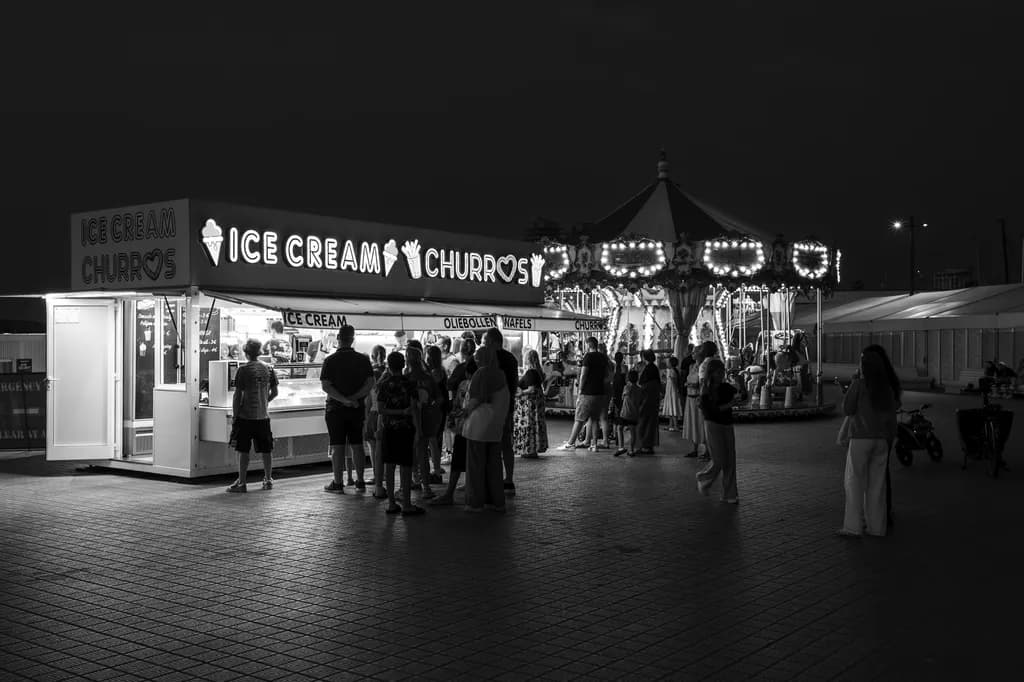 Whispers of Night: A Black and White Carnival Scene with Ice Cream and Churros