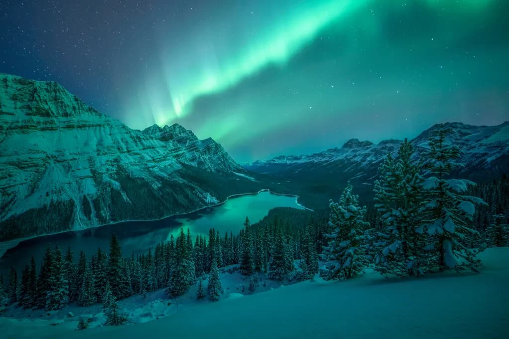 Whispers of the Aurora: A Serene Winter's Night Over Frozen Peaks and Tranquil Waters