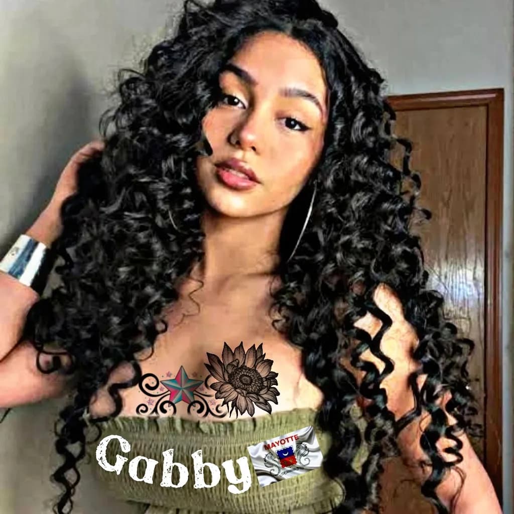 Curly Elegance: A Portrait of Gabby with Floral Tattoos and Cultural Pride