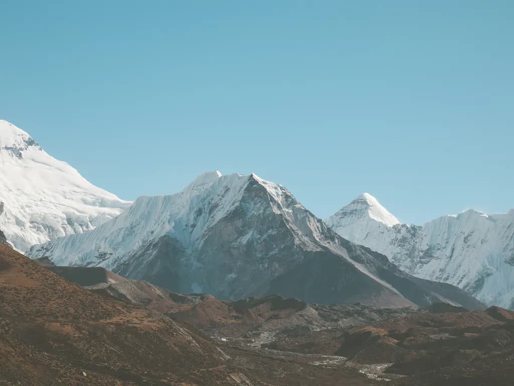 Majestic Peaks: A Serene Winter Landscape of Snow-Capped Mountains and Clear Blue Skies