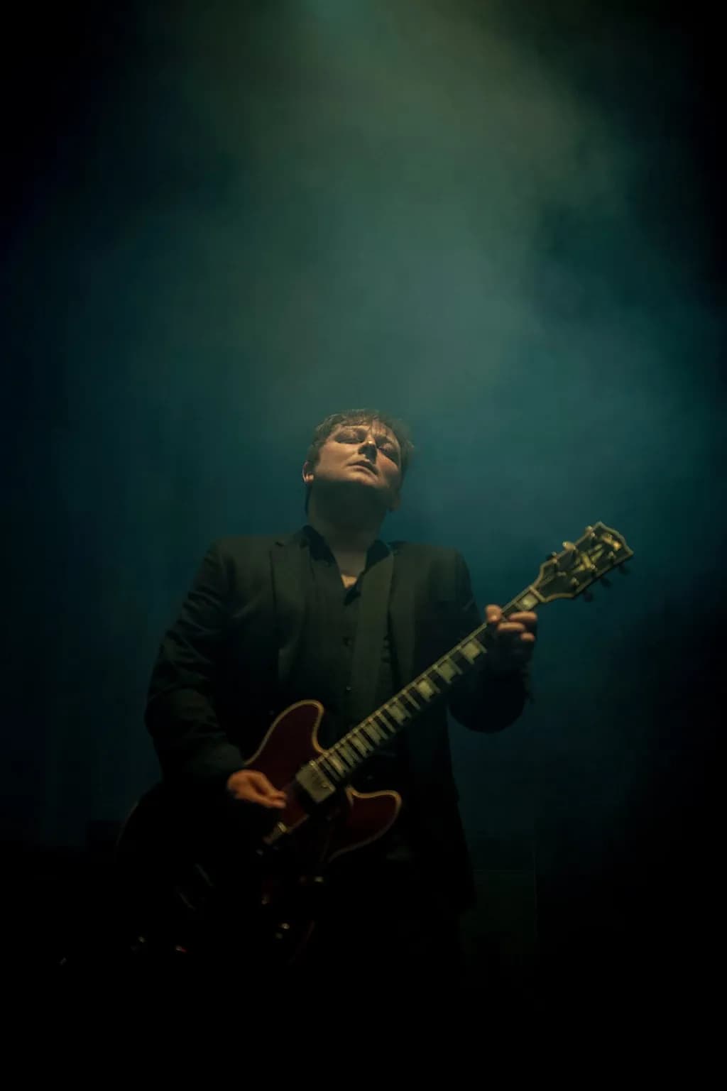 Ethereal Guitarist: A Dramatic Stage Performance in Enigmatic Lighting