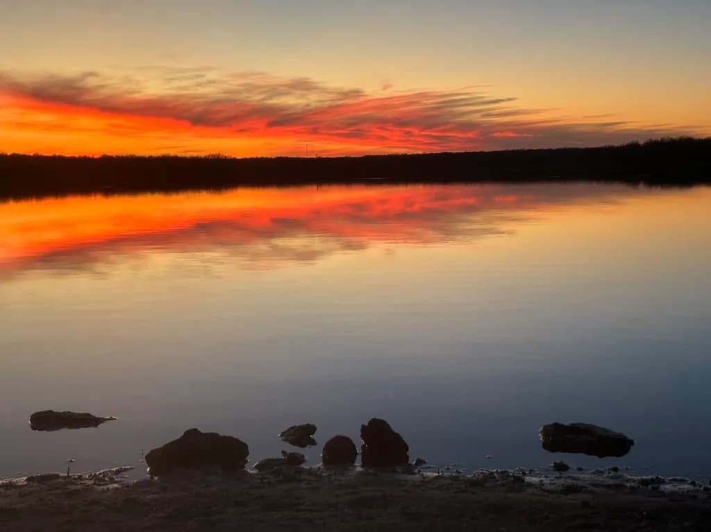 Serene Sunset Reflections: A Tranquil Landscape of Colorful Waters at Dusk