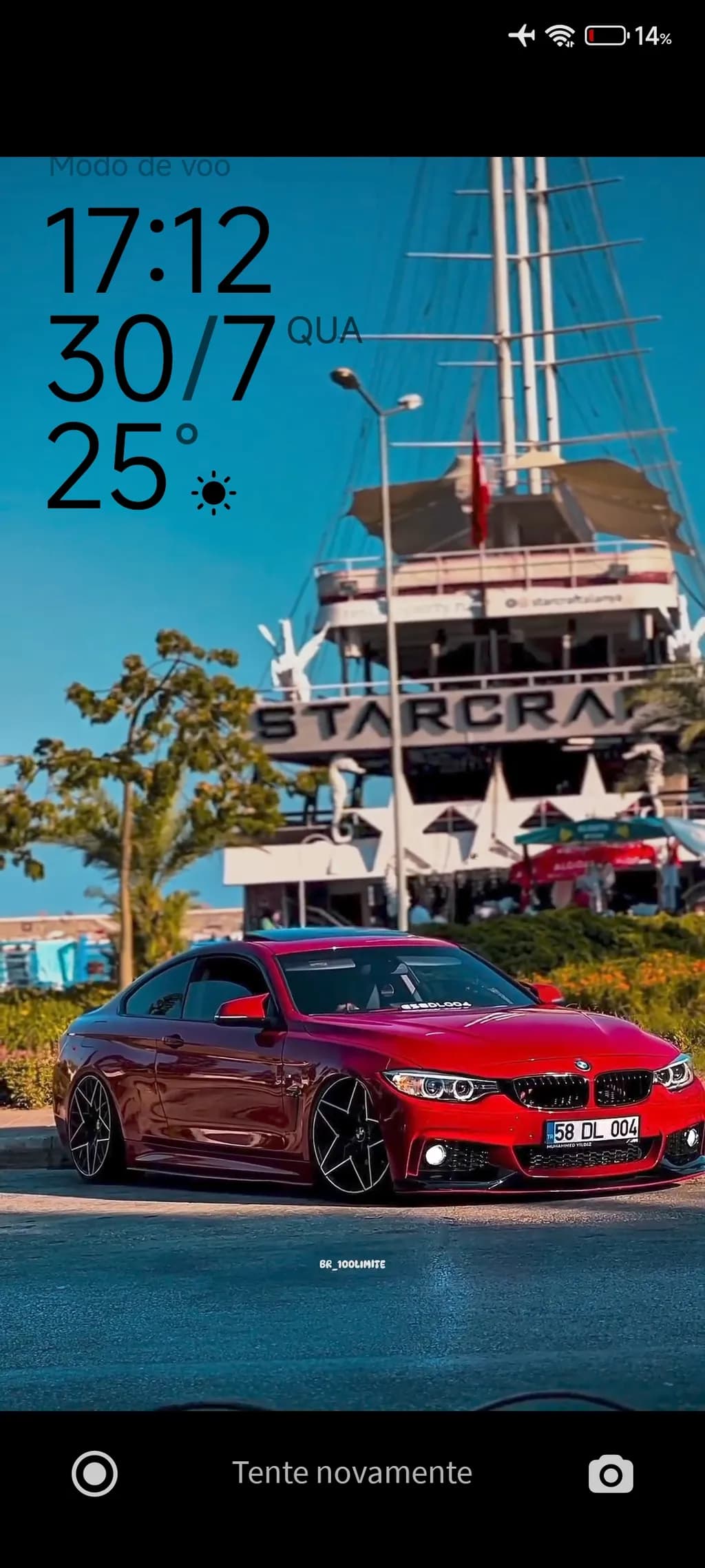 Vibrant Elegance: A Red BMW Coupe Against a Coastal Backdrop