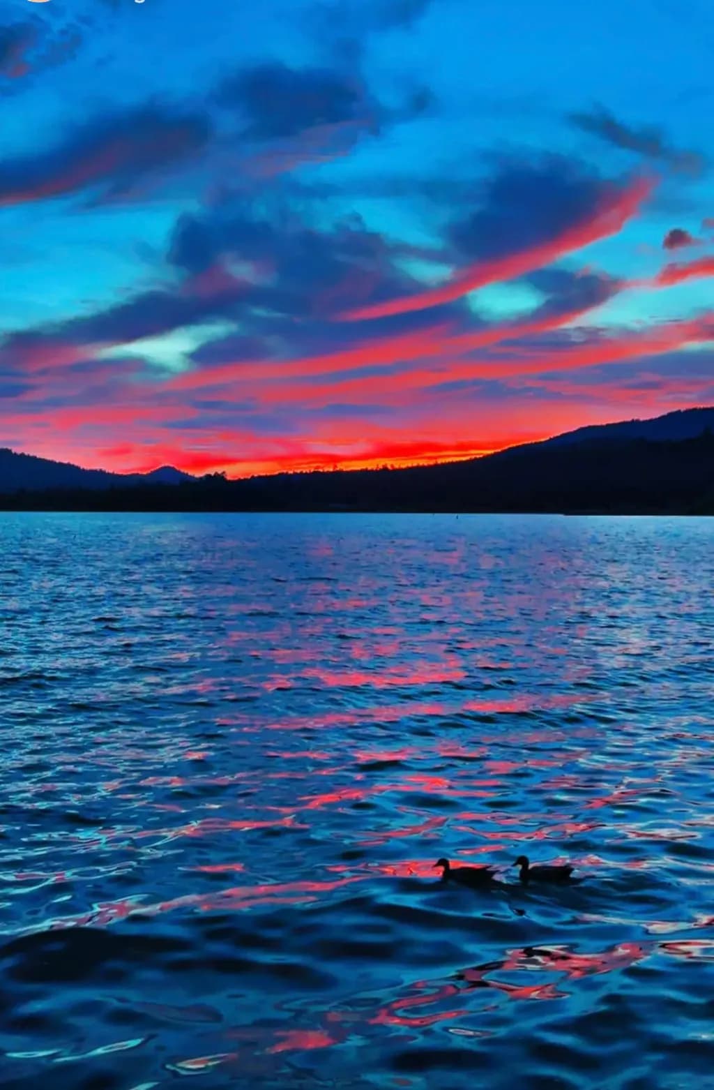 Whispers of Twilight: A Serene Dance of Colors Over Water