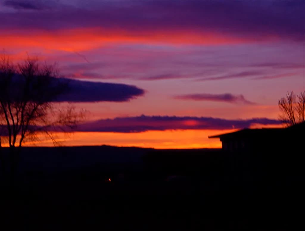 Whispers of Twilight: A Serene Sunset Over Silhouetted Horizons