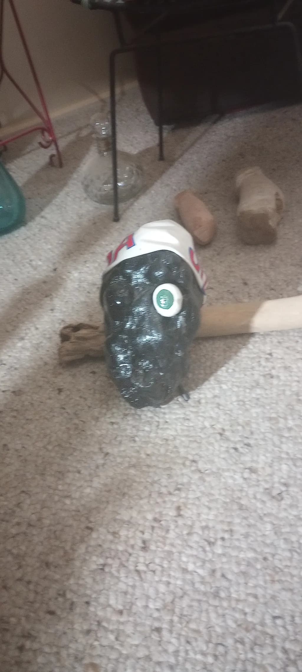 Whimsical Black Skull with Green Eye and Cap: A Unique Artistic Creation