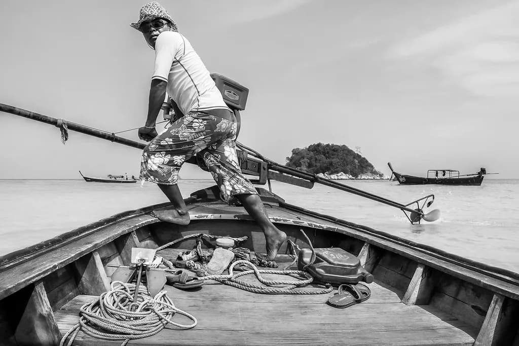 "Navigating Serenity: A Fisherman's Journey in Monochrome"