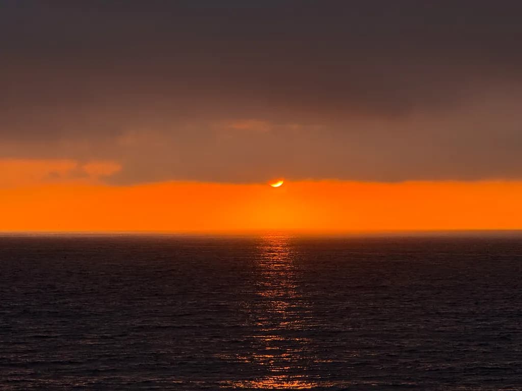 Ethereal Sunset Over Tranquil Waters: A Serene Oceanic Horizon at Dusk