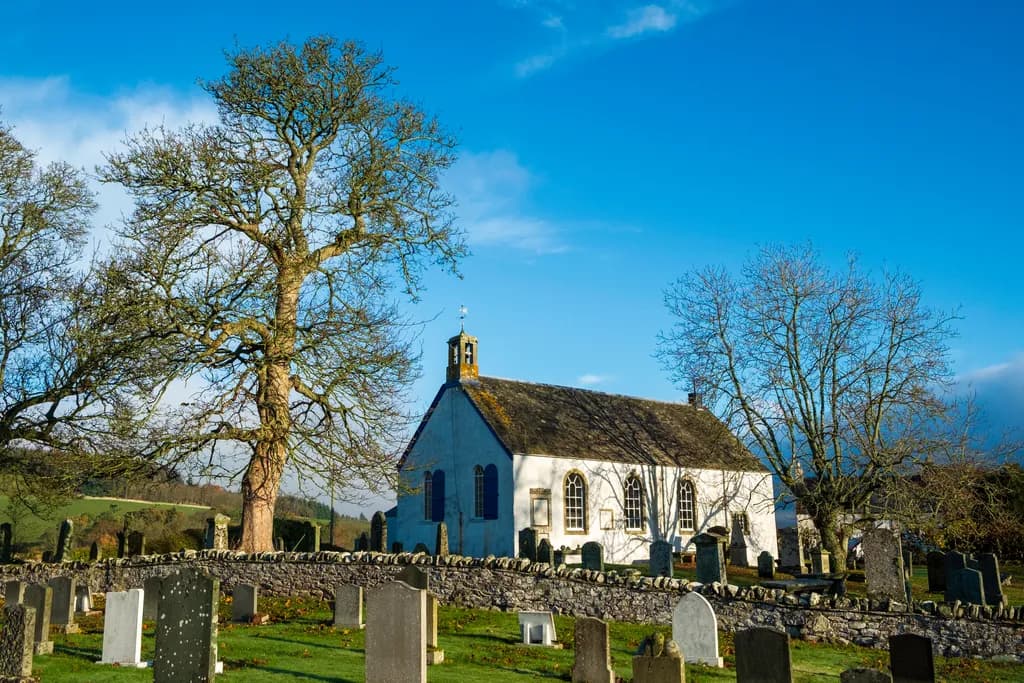 Serene Scottish Church Amidst a Tranquil Graveyard Landscape