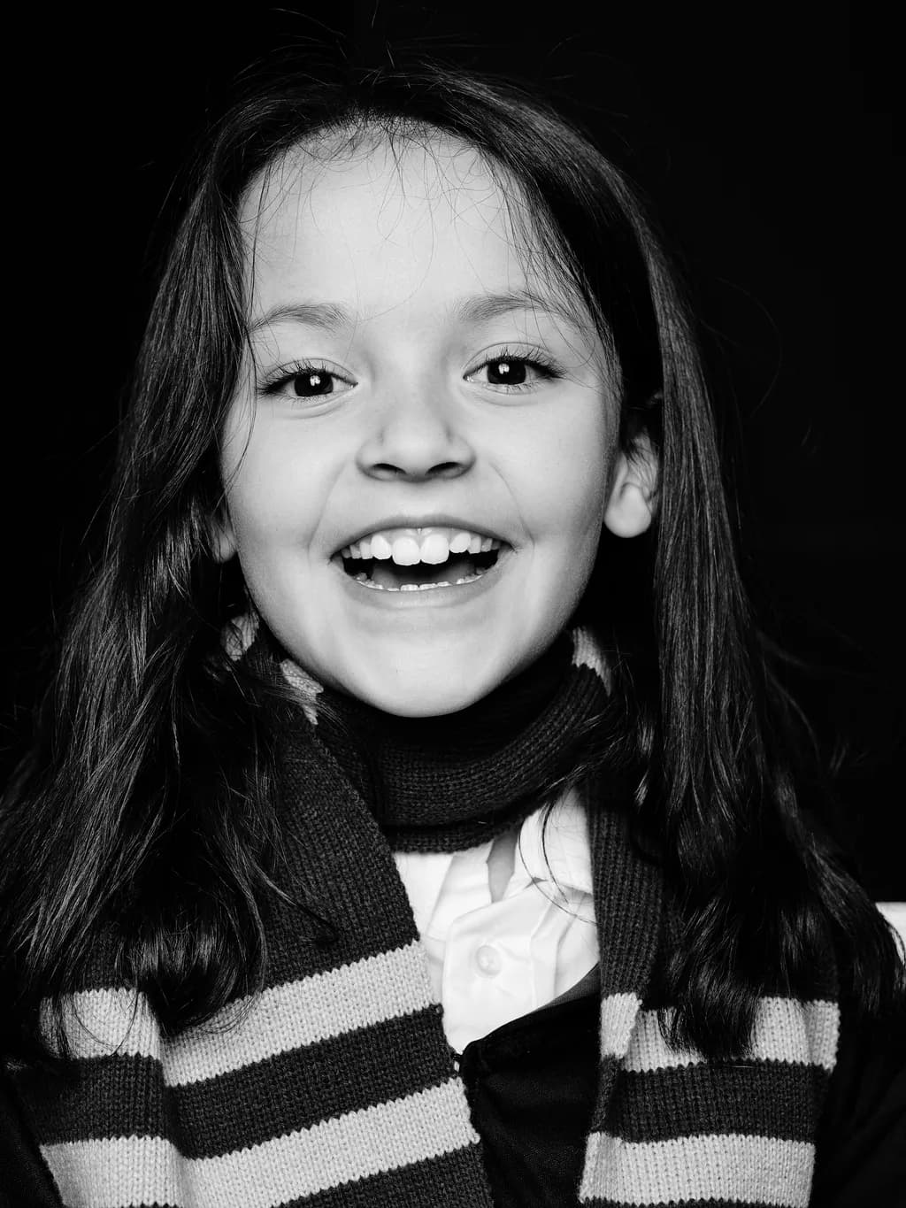 Joyful Innocence: A Black and White Portrait of a Smiling Child