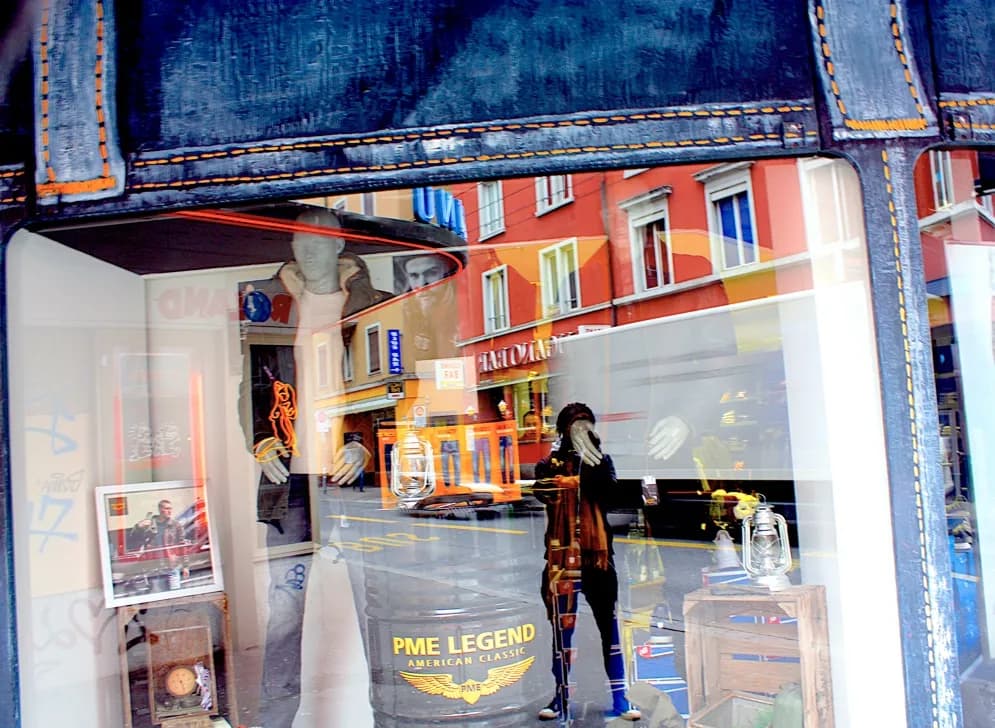 Urban Reflections: A Glimpse into Fashion and Life Through a Storefront Window