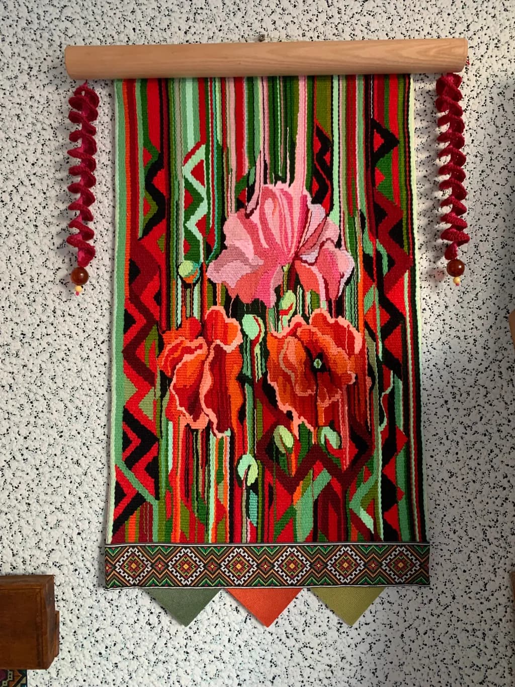 Vibrant Floral Tapestry: A Colorful Textile Wall Hanging with Bold Patterns and Decorative Elements
