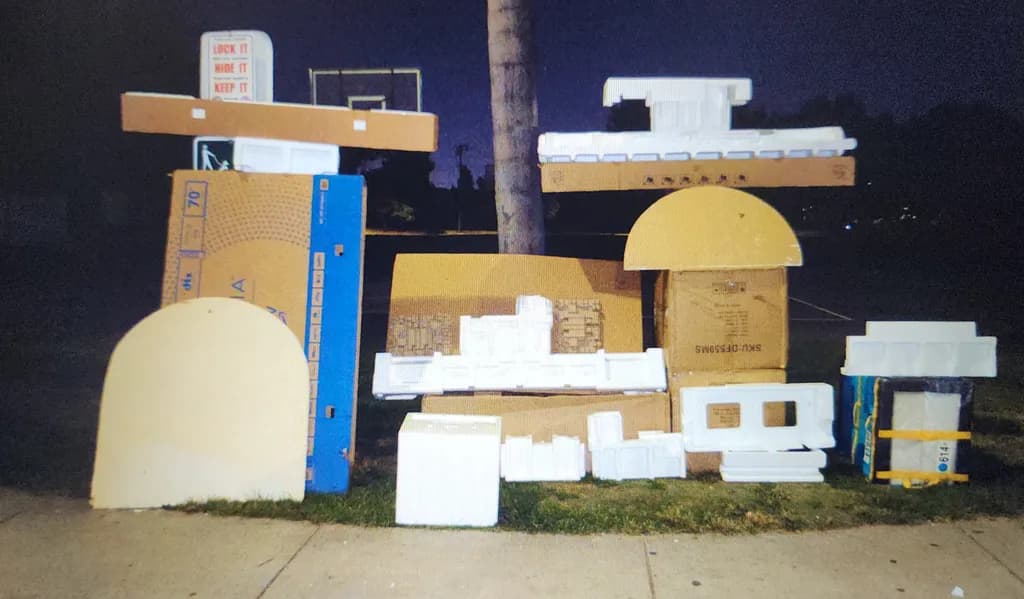 Urban Canvas: A Nighttime Assembly of Cardboard Dreams