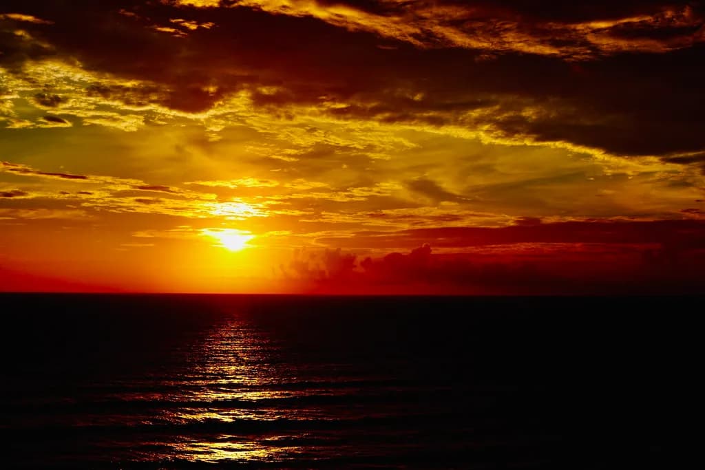 Eternal Embrace: A Fiery Sunset Over Tranquil Waters