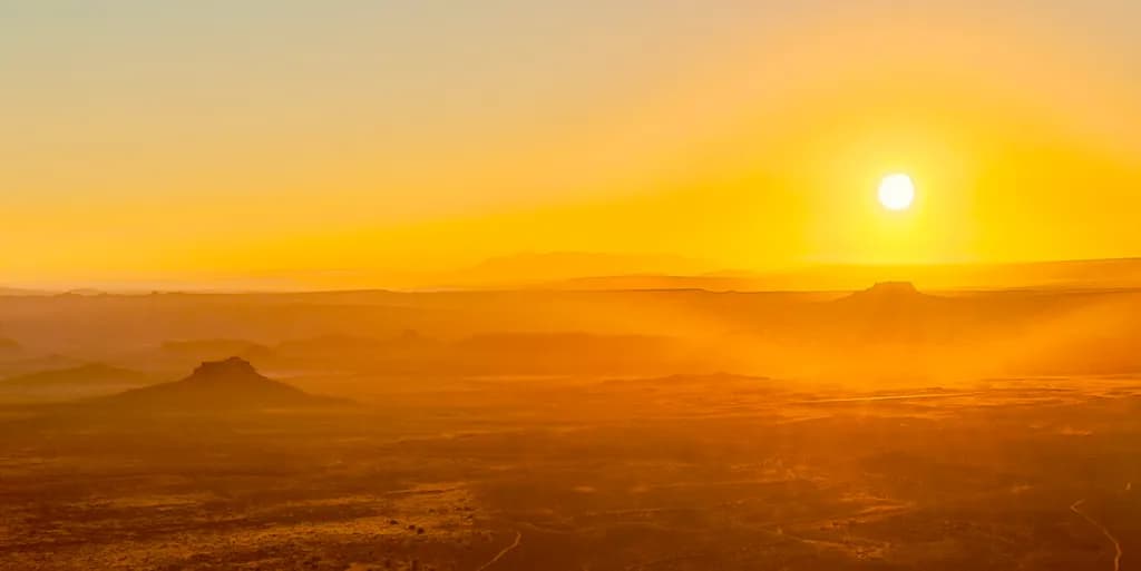 Golden Horizon: A Serene Sunset Over the Desert Landscape