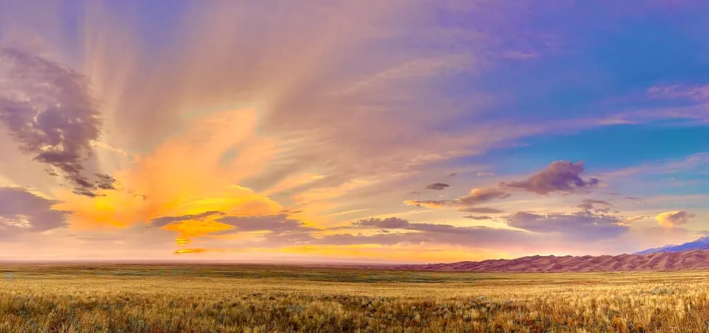 Whispers of Dusk: A Vibrant Sunset Over Endless Grasslands