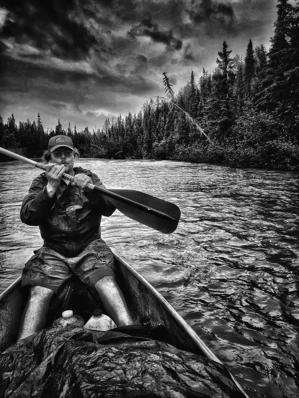 Silent Waters: A Journey Through Shadows and Reflections in Black and White Canoeing Adventure