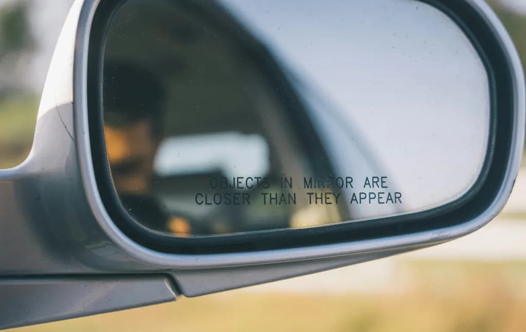 Reflections of Reality: The Illusion of Distance in a Rearview Mirror