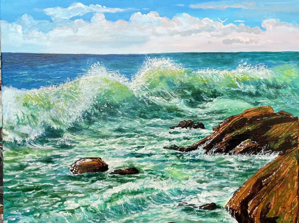 Ocean's Embrace: Waves Dancing Over Rocky Shores Under a Blue Sky