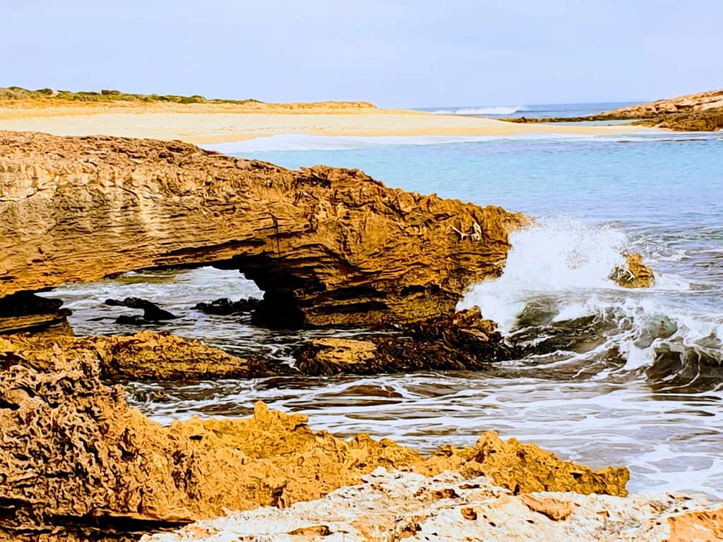 Serenity at the Shore: A Coastal Landscape of Waves and Rock Formations