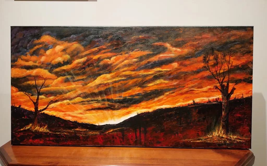 Ethereal Sunset: A Dramatic Landscape of Fiery Colors and Silhouetted Trees